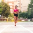 latin sportswoman running on the city wearing a sports bra